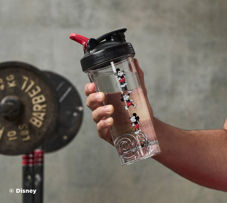 pro-series-v6 Mickey_Mouse_Protein_Shaker_Bottle_Being_Held_In_the_Gym.jpg